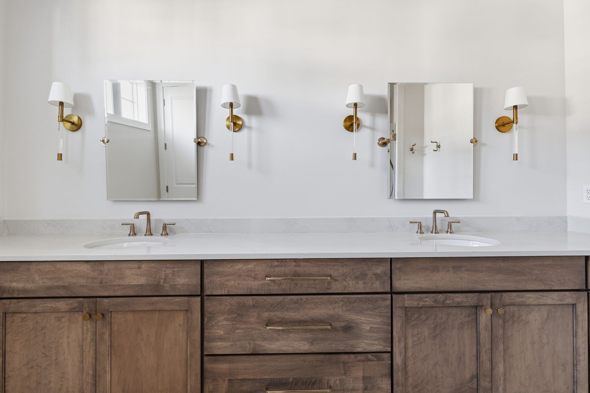 bathroom vanity with two mirrors and sinks above wood cabinet