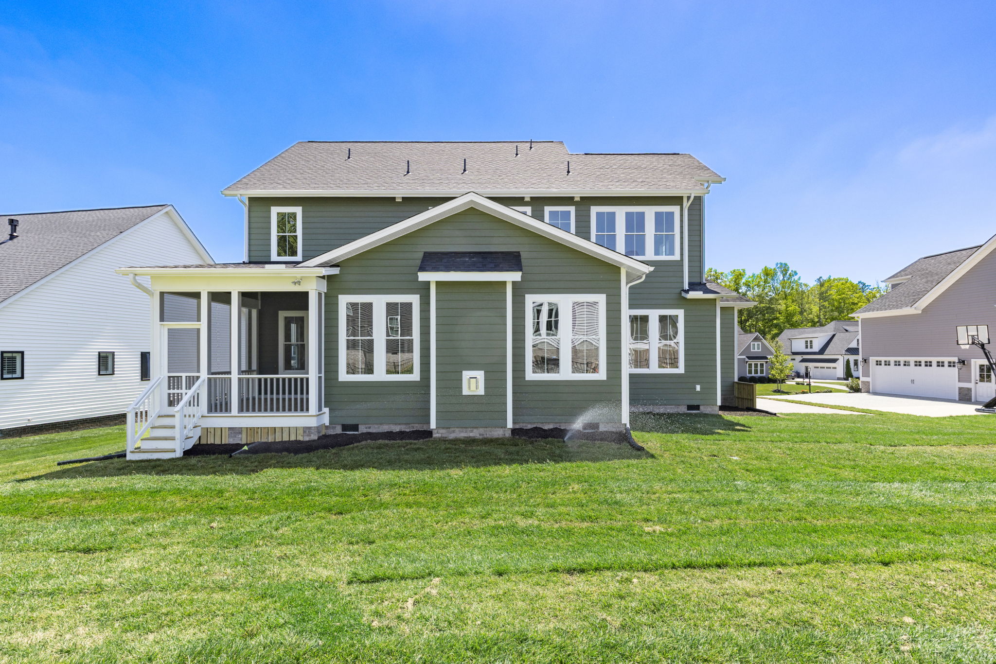 Rear view of house with yard and screened in porch